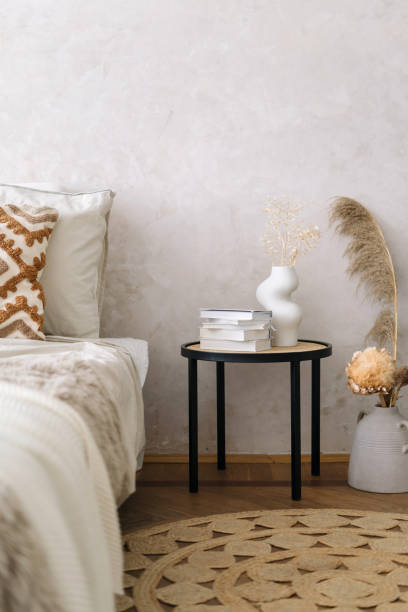 Nightstand close to bed with decorative bedroom textile