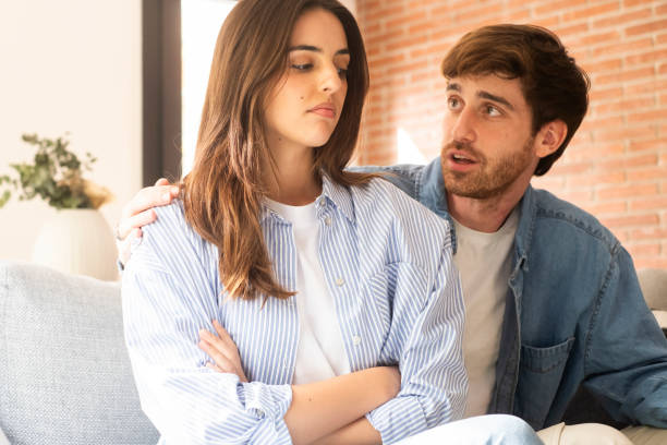 istock Engaged couple with relationship problems sitting on the sofa with their backs to each other after an argument, conflicts in marriage, upset couple after a dispute, making decision to break up and divorce 2163488992