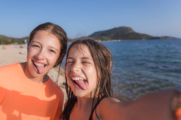 Girls making funny faces when taking a selfie