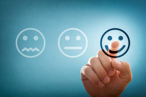 istock Hand selecting happy emoticon from three options as positive rating 2163490817