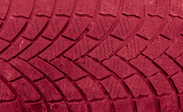 istock tire tread, tire traces background red 2163490866