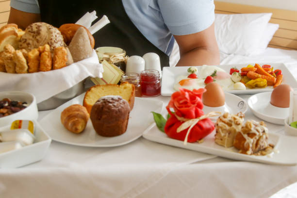istock Room service hotel staff carries breakfast tray 2163491078