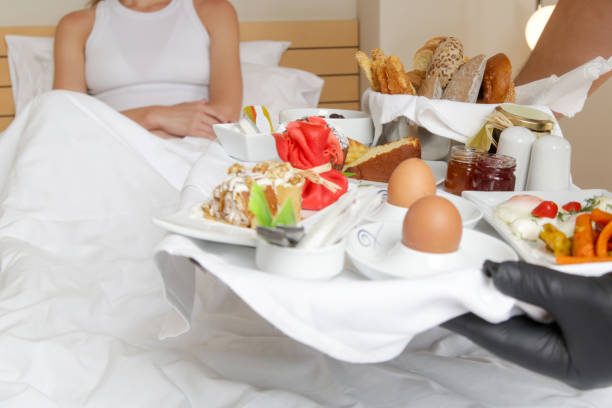 istock Room service hotel staff carries breakfast tray 2163491138
