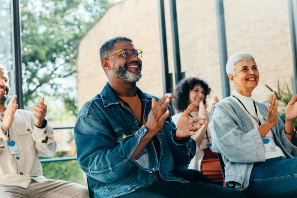 istock Adults in an audience clapping during a seminar. 2163491648