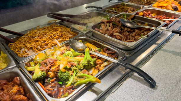 istock various Asian dishes, including stir-fried noodles, beef and broccoli, and mixed vegetables 2163491649