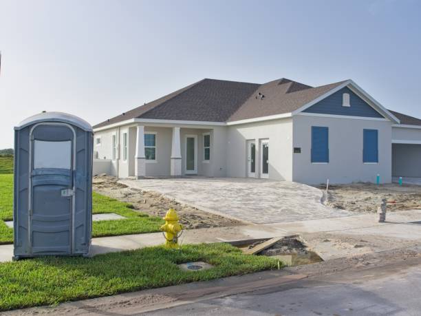 Newly not quite finished home with construction porta potty in front. Construction in Florida's booming real estate market.
