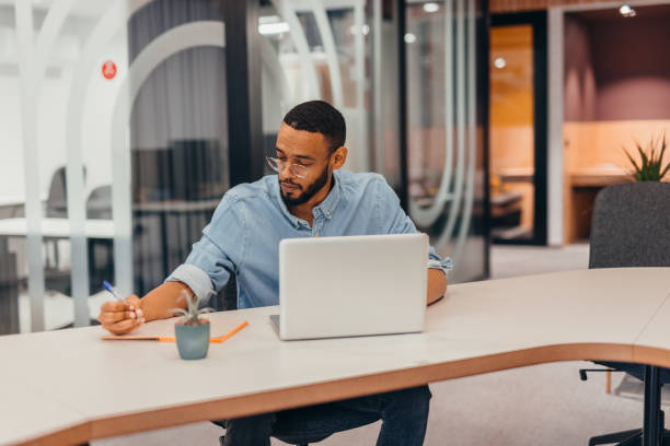istock Cheerful businessman working on his laptop 2163492262