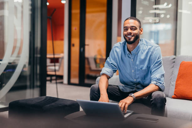 istock Cheerful businessman working on his laptop 2163493650