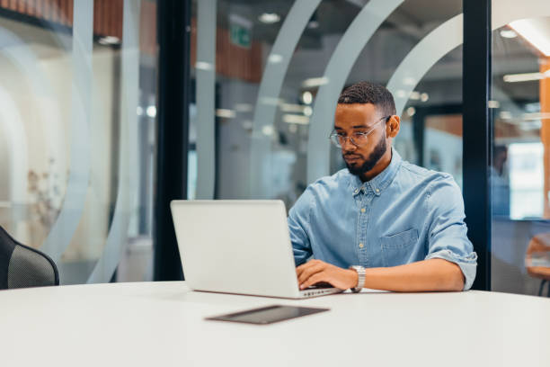 Cheerful businessman working on his laptop