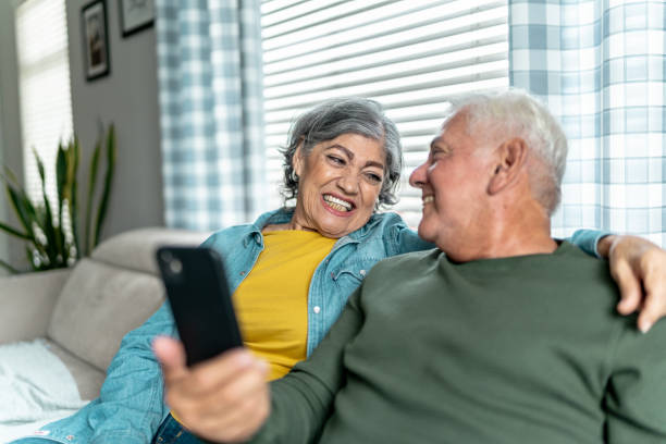 istock Senior couple using mobile phone at home 2163494234