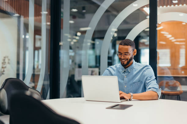 istock Cheerful businessman working on his laptop 2163494508