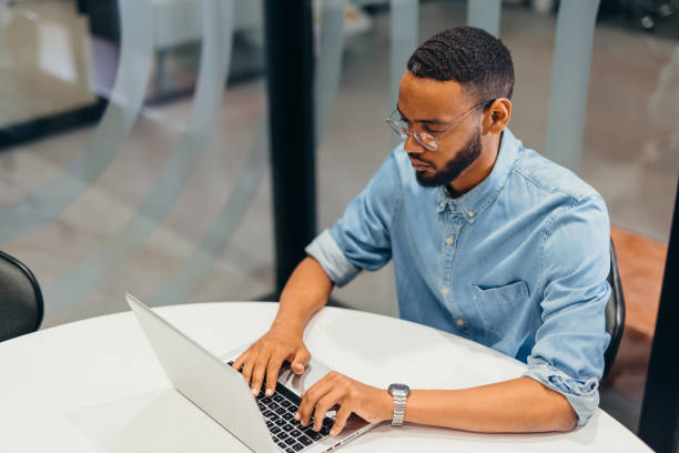 istock Cheerful businessman working on his laptop 2163494614