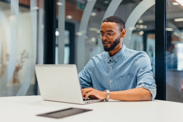 istock Cheerful businessman working on his laptop 2163494615