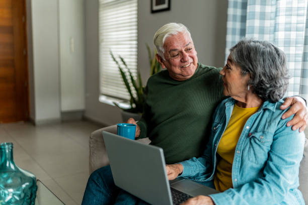 istock Senior couple using computer and talk at home 2163494651