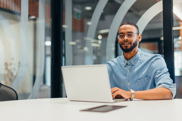 istock Cheerful businessman working on his laptop 2163494856