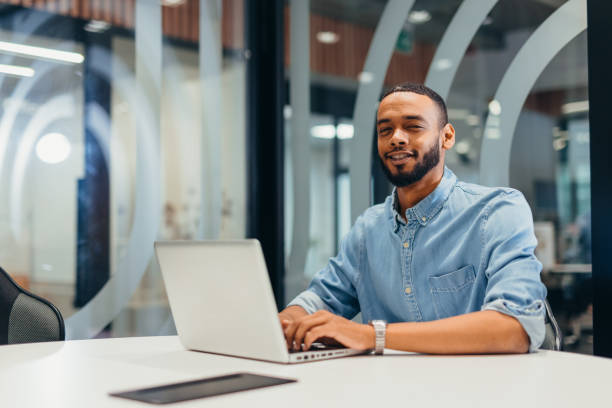 istock Cheerful businessman working on his laptop 2163494858