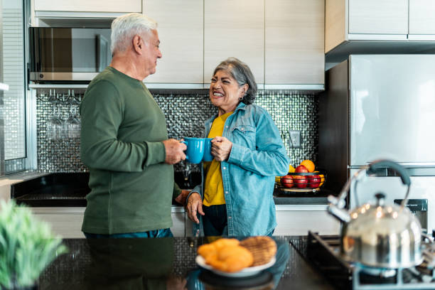 istock Senior couple talking in kitchen at home 2163495285