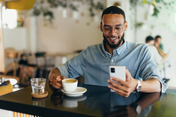 istock Young business man texting on his phone at a cafe 2163495831