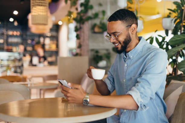 istock Young business man texting on his phone at a cafe 2163496859