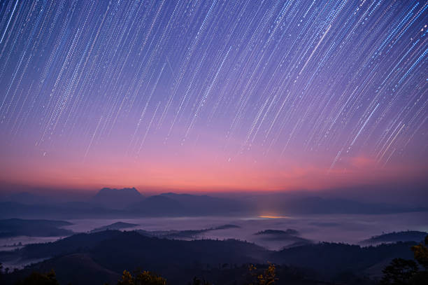 istock Star Trails Over Misty Mountain Landscape at Dawn 2163499380