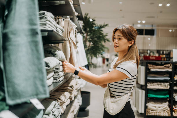 istock Shopping Elegance: A Young Asian Woman’s Guess Towel Discovery 2163501004