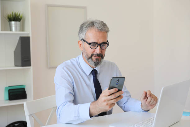 istock A Middle-Aged Businessman in His Office Dealing with Ongoing Successes and Challenges Throughout the Workday. Office Background. 2163502181