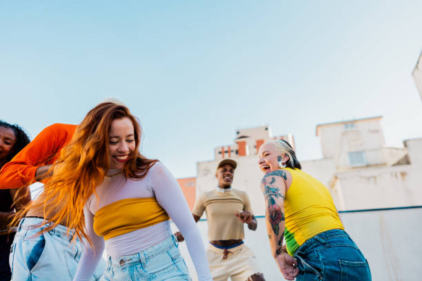 istock Young woman friends dancing at rooftop 2163503685