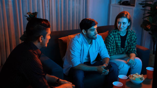 istock Father and mother watching movie while eating snack with friend. Convocation. 2163503753