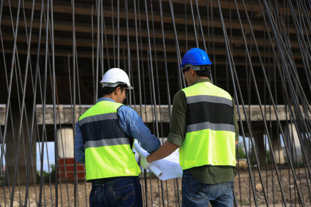 istock Pile Construction, Civil engineer working with blueprint drawing at steel frame for pile construction site of the infrastructure of the new bridge highway project 2163503949