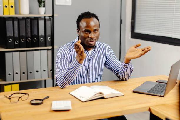 istock Professional man working on laptop at desk 2163504260