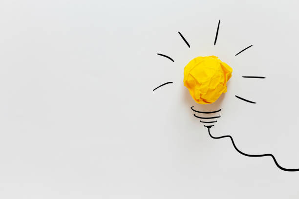 istock Yellow crumpled paper light bulb drawn on a white background. Brainstorm and creative idea, concept. Project and startup 2163505865