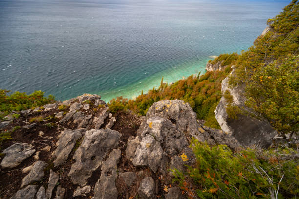 istock Lake Huron turquoise waterfront surrounded by Limestone Rocky Cliffs with Trees, autumn day landscape 2163506206