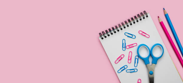 istock Empty notebook and school stationery on a pink background. Banner. Back to school. Flatlay. Top view. Copy space. 2163506992