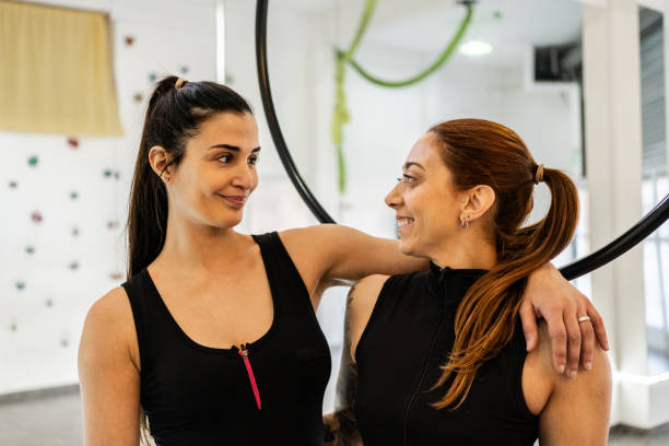 Female friends embracing in a studio