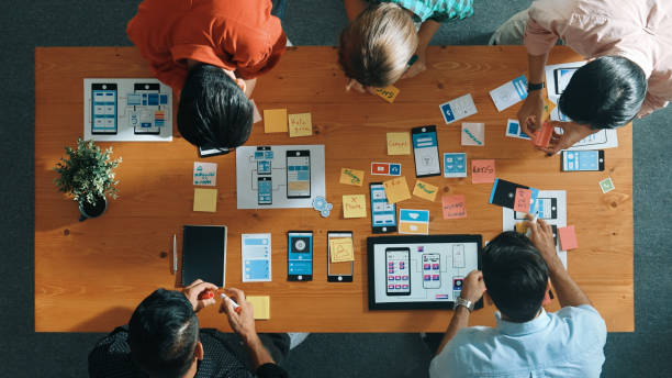 istock Top view of skilled business team writing idea on sticky note. Convocation. 2163509312