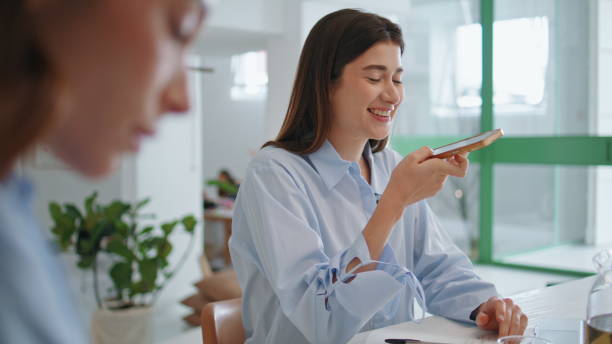 istock Happy manager talking smartphone microphone. Smiling woman recording message 2163511156