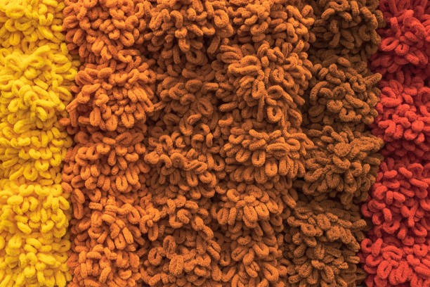 Fluffy plush yarn in cozy colors. Crocheting and knitting. A calm and safe hobby. Yarn texture close-up. Handicraft store. A wound thread. Color gradient. Matte image. Home comfort. Seasonal leisure time for fall and winter. Warm clothing. Knitted things.