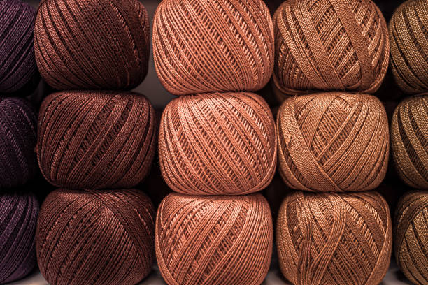 Fluffy plush yarn in cozy colors. Crocheting and knitting. A calm and safe hobby. Yarn texture close-up. Handicraft store. A wound thread. Color gradient. Matte image. Home comfort. Seasonal leisure time for fall and winter. Warm clothing. Knitted things.