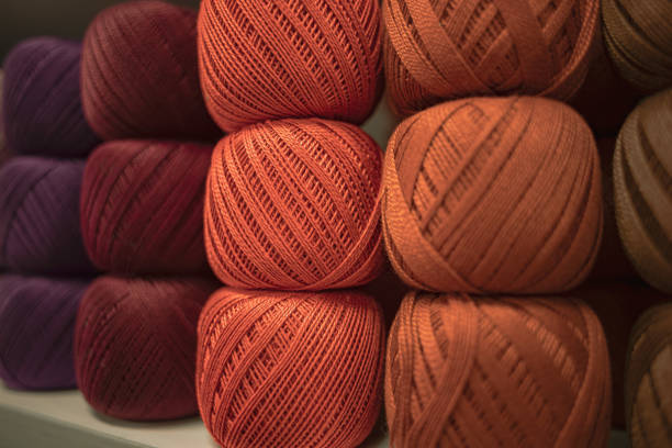 Fluffy plush yarn in cozy colors. Crocheting and knitting. A calm and safe hobby. Yarn texture close-up. Handicraft store. A wound thread. Color gradient. Matte image. Home comfort. Seasonal leisure time for fall and winter. Warm clothing. Knitted things.