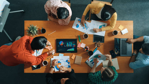 istock Top view of investor brainstorm while look at financial statistic. Convocation. 2163511857