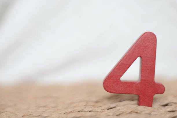 Close-up wooden red figure number four on a white blurred background, holiday date, anniversary, jubilee greeting card with copy space for text