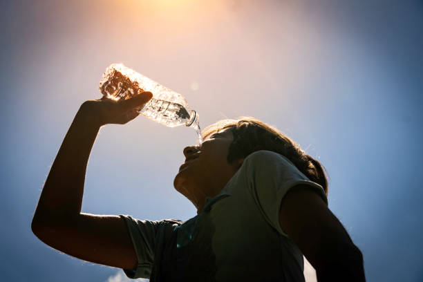 istock Boy drinking water from a bottle on a sunny hot day. 2163514284