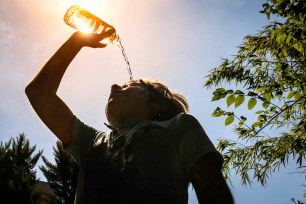 istock Boy drinking water from a bottle on a sunny hot day. 2163514299