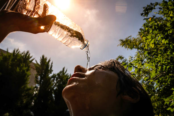 istock Boy drinking water from a bottle on a sunny hot day. 2163514302