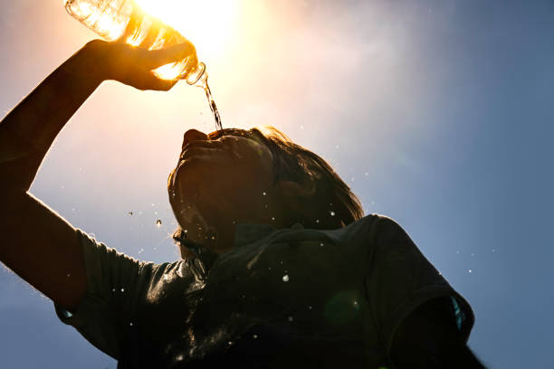 istock Boy drinking water from a bottle on a sunny hot day. 2163514304