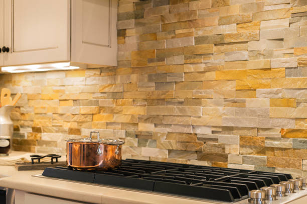 istock Modern Kitchen With Stone Backsplash And Copper Pot On The Stovetop. 2163514335