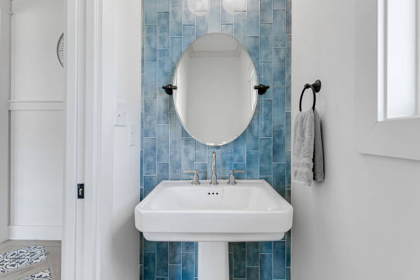 istock Modern Bathroom Sink With Round Mirror And Blue Subway Tile Backsplash. 2163514797