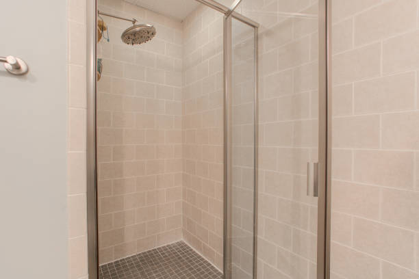 istock Chic Modern Bathroom Shower With Glass Doors And Beige Tiled Walls. 2163514881