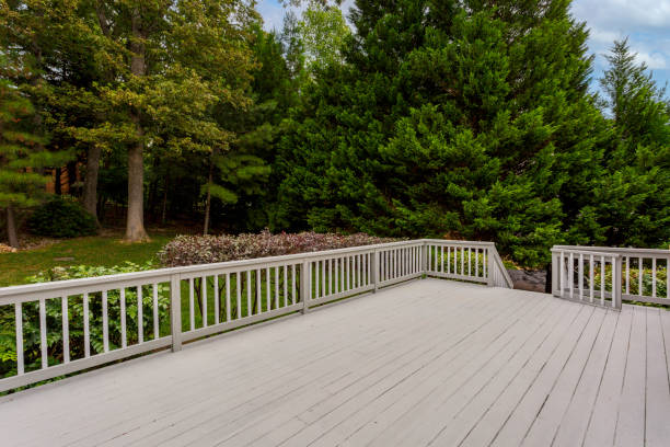 istock White Wooden Deck Surrounded By Green Foliage And Clear Blue Sky. 2163514986
