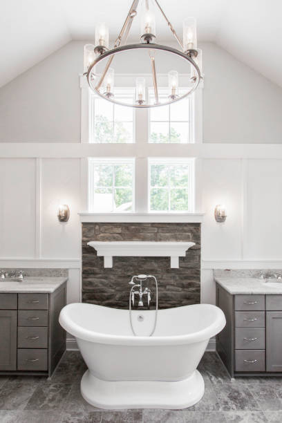 istock Luxurious Bathroom With Freestanding Tub, Stone Wall, Dual Sinks, And Window View. 2163515158
